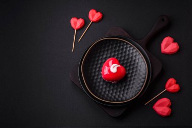 Beautiful tasty cake red color cheesecake in the shape of a heart. Sweets for Valentine's Day