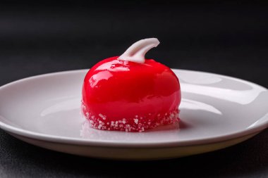 Beautiful tasty cake red color cheesecake in the shape of a heart. Sweets for Valentine's Day