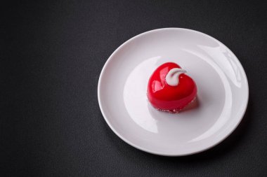 Beautiful tasty cake red color cheesecake in the shape of a heart. Sweets for Valentine's Day
