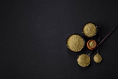 Spice dried dill or basil in the form of green powder. Asian cuisine