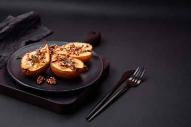 Delicious baked pear with dorblu cheese, walnut and honey on a textured concrete background. Vegetarian dish