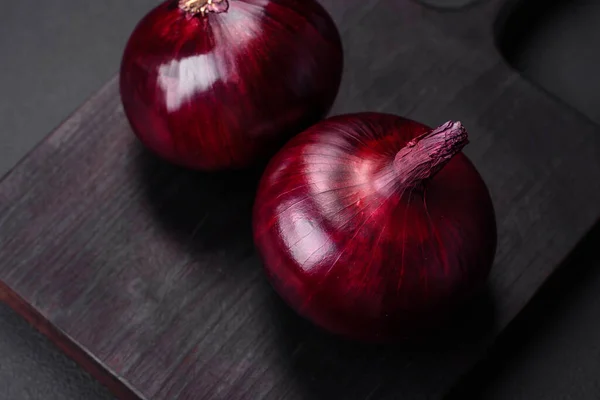 stock image Fresh raw red onion on dark textured concrete background. Cooking at home