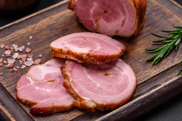 stock image Delicious fresh baked meat roll with spices and herbs on a dark concrete background