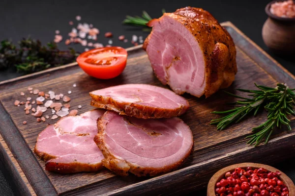 stock image Delicious fresh baked meat roll with spices and herbs on a dark concrete background