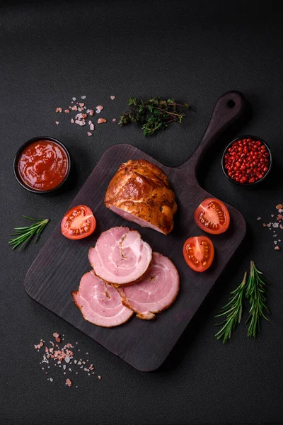 stock image Delicious fresh baked meat roll with spices and herbs on a dark concrete background