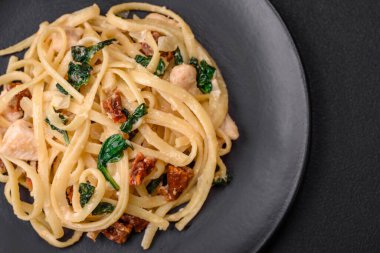 Ispanaklı, güneşte kurutulmuş domatesli, peynirli, soğanlı, baharatlı ve çimento kaplı lezzetli bir makarna.