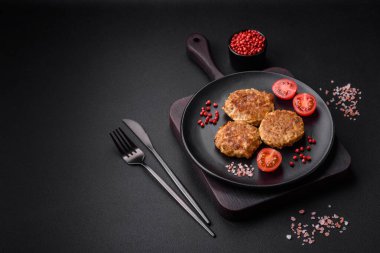 Lezzetli taze kıymalı balık pirzolası. Esmer arka planda baharatlar ve otlarla birlikte.