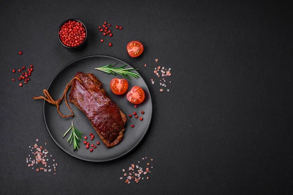 stock image Delicious duck fillet or breast grilled or smoked with spices and salt on a dark concrete background