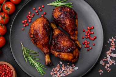 Lezzetli ızgara tavuk bacağı. Baharatlı ve otlu teriyaki soslu. Koyu beton arka planda.