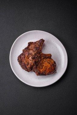 Lezzetli biftek ya da kemikte ızgara biftek, baharat ve koyu beton arka planda biberiye.