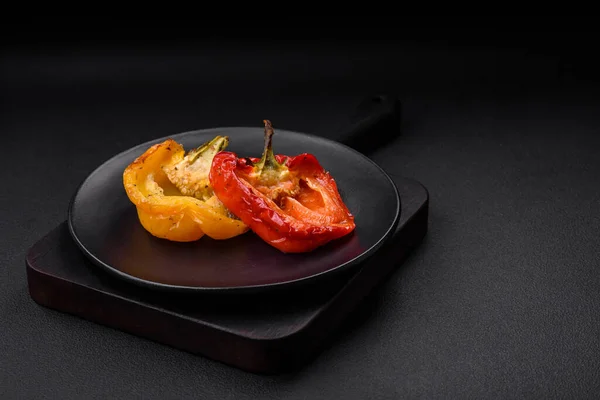 stock image Delicious juicy grilled peppers with spices and herbs on a dark concrete background