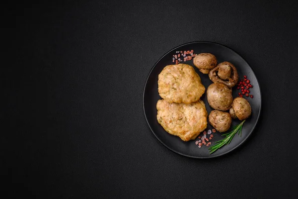 stock image Delicious fried chopped fillet pancakes with spices, salt and herbs on a dark concrete background