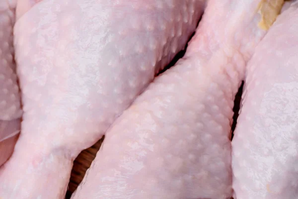 Stock image Raw chicken legs with salt, spices and herbs on a dark concrete background