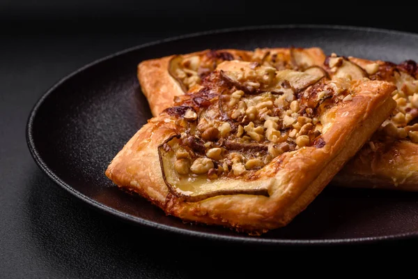 stock image Delicious fresh sweet pie or pizza with pear, brie cheese, honey and nuts on a dark concrete background