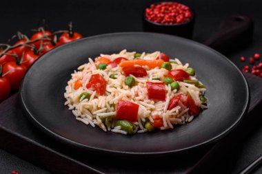 Lezzetli haşlanmış pirinç, biber, bezelye, kuşkonmaz fasulyesi ve havuç ve beton kaplama.