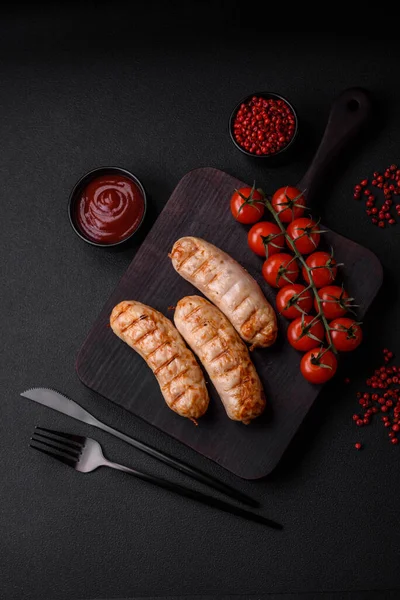 stock image Delicious grilled sausages from chicken or pork meat with salt, spices and herbs on a textured concrete background