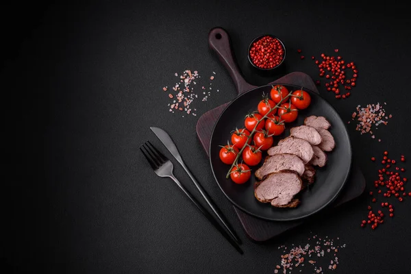 stock image Delicious beef steak with salt, spices and herbs on a ceramic plate on a dark concrete background