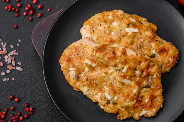 stock image Delicious fried chicken breast in batter with mustard, salt, spices and cheese on a dark concrete background