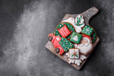 Güzel renkli Noel kurabiyeleri desenli beton arka plandaki festival masasının tasarımı ve dekorasyonu için.