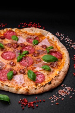 Salamlı, etli, peynirli, domatesli, baharatlı ve çimento kaplı lezzetli fırın fırınlanmış pizza.