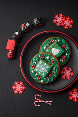 Koyu beton bir zeminde seramik tabakta ev yapımı zencefilli kurabiyeler.