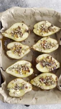 Delicious baked pear with dorblu cheese, walnut and honey on a textured concrete background. Vegetarian dish
