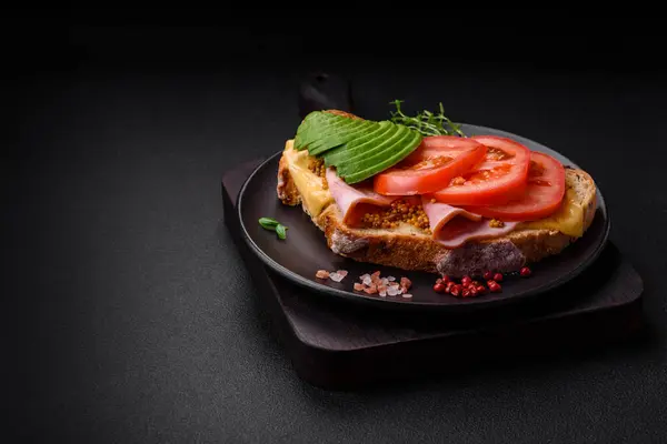美味的营养烤土司 西红柿和鳄梨配盐 香料和香草 背景为深色混凝土 — 图库照片