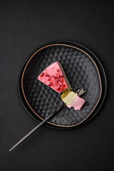 stock image Delicious sweet dessert cheesecake with raspberry and pistachio flavor on textured concrete background