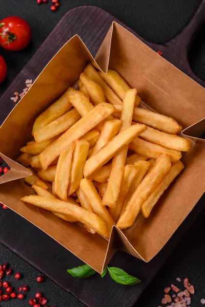 Delicious Crispy French Fries Salt Spices Cardboard Box Dark Concrete — Stock Photo, Image