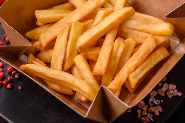 Delicious Crispy French Fries Salt Spices Cardboard Box Dark Concrete — Stock Photo, Image