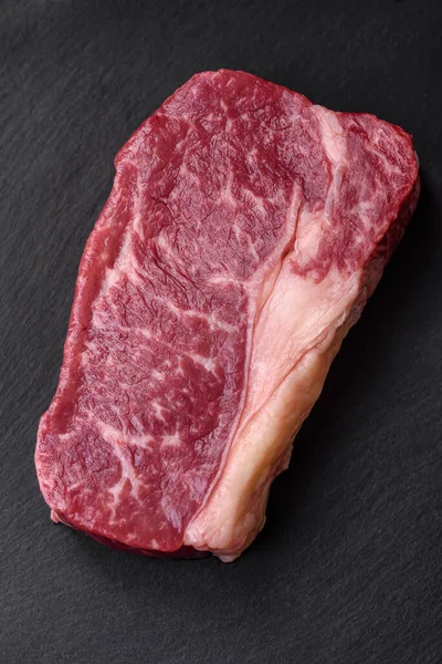 Fresh Raw Beef Striploin Steak Salt Spices Herbs Dark Concrete — Stock Photo, Image