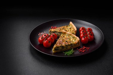 Brokolili, peynirli, baharatlı ve otlu lezzetli taze kiş koyu beton bir arka planda parçalara bölünmüş.