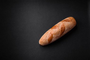 Koyu desenli beton arka planda Fransız ekmeği. Evde nefis bruschetta yapıyorum.