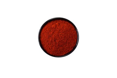 Spice smoked paprika in the form of powder in bowls and spoons on a dark concrete background. Asian cuisine ingredients