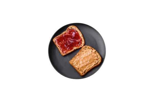 Nutritious Sandwiches Consisting Bread Raspberry Jam Peanut Butter Black Ceramic — Stock Fotó