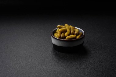 Soğanlı, hardallı, tuzlu ve baharatlı küçük salatalıklı salatalık turşusu.