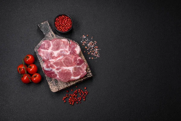 濃いコンクリートの背景に塩 スパイス ハーブで新鮮なジューシーな豚肉ステーキ — ストック写真