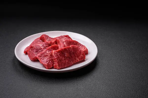 Frische Saftige Rohe Rindfleischscheiben Mit Salz Und Gewürzen Auf Dunklem — Stockfoto