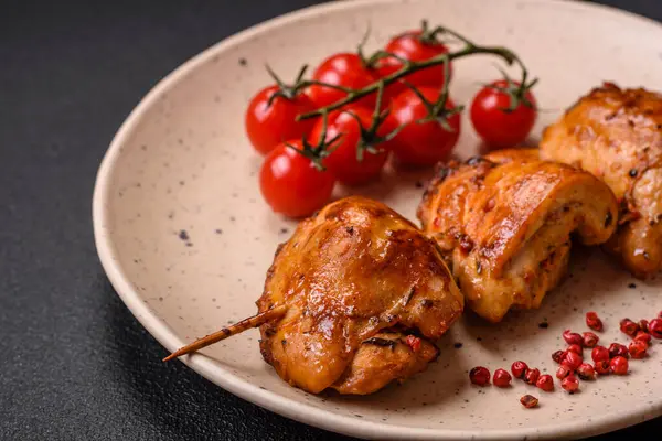 Delicious fresh chicken kebab with salt, spices and herbs on a dark concrete background