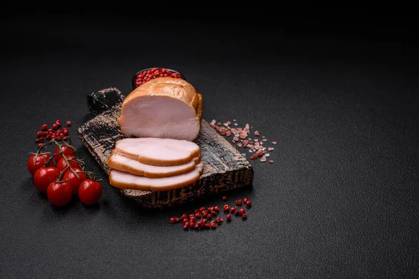 Delicious smoked pork or chicken meat with salt, spices and herbs on a dark concrete background
