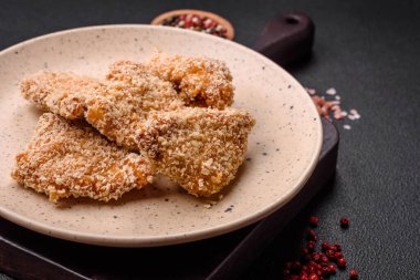 Delicious fresh crispy chicken nuggets on a dark concrete background. Unhealthy food, fast food