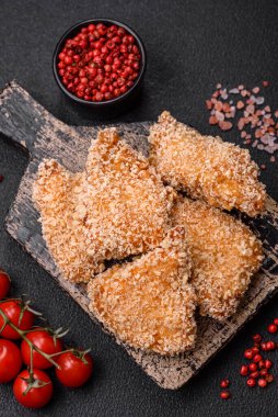 Delicious fresh crispy chicken nuggets on a dark concrete background. Unhealthy food, fast food