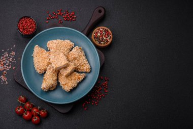 Delicious fresh crispy chicken nuggets on a dark concrete background. Unhealthy food, fast food