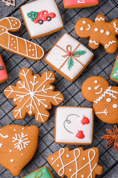 Beautiful delicious sweet winter Christmas gingerbread cookies on a gray textured background. Preparing for a family holiday