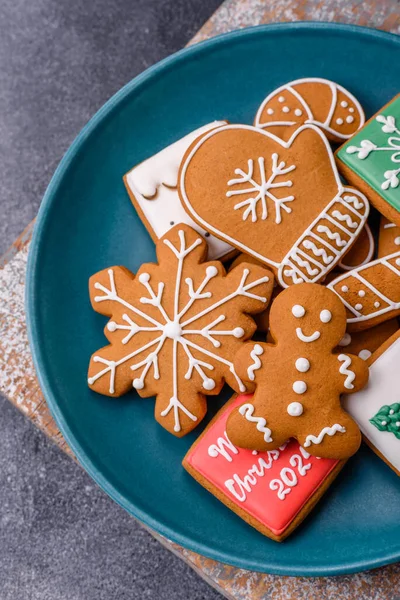 Beautiful delicious sweet winter Christmas gingerbread cookies on a gray textured background. Preparing for a family holiday