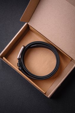 Koyu beton arka planda eski tarz metal tokalı yeni deri erkek kemeri.