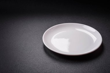 Dökümlü beton zemin üzerinde şişkin boş seramik bir tabak. Mutfak aletleri