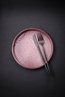 Dökümlü beton zemin üzerinde şişkin boş seramik bir tabak. Mutfak aletleri