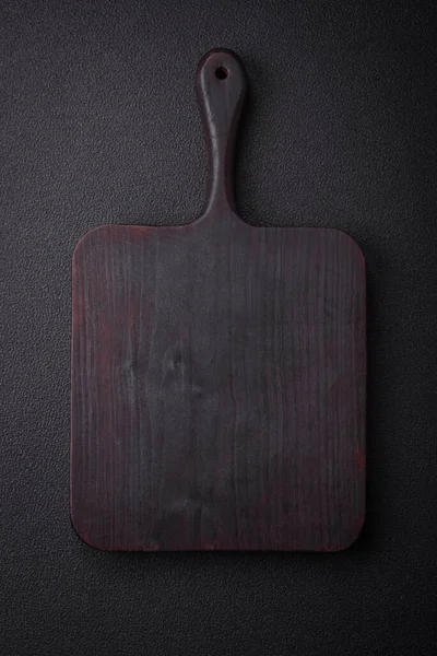 Empty wooden cutting board for preparing ingredients for preparing a delicious dish. Kitchen utensils