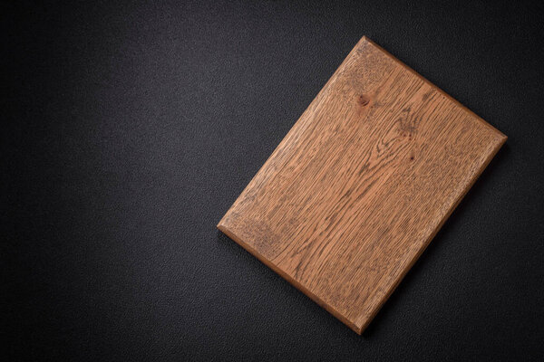 Empty wooden cutting board for preparing ingredients for preparing a delicious dish. Kitchen utensils